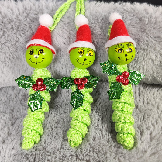 Grüner Grantler – Handgehäkeltes Sorgenwürmchen mit Weihnachtsmütze & Mistelzweig